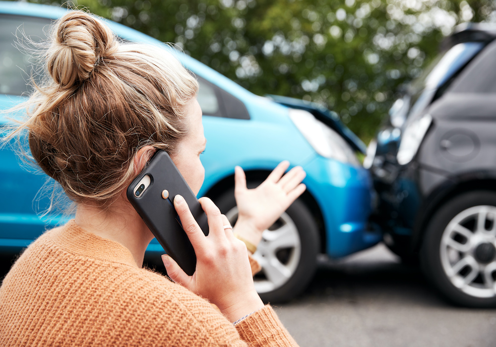 Female Motorist Involved In Car Accident Calling Insurance Company